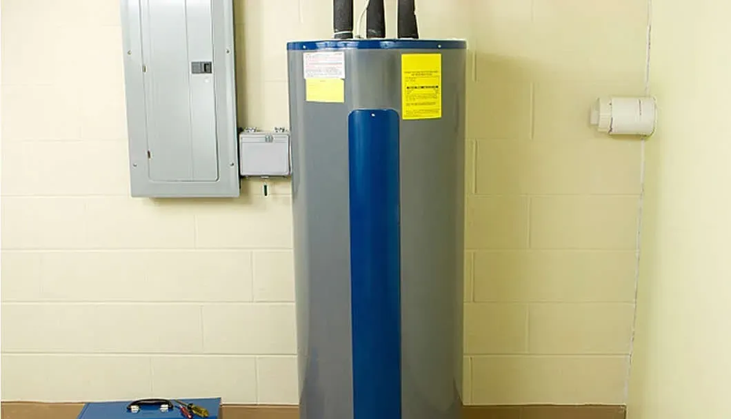 Conventional tank water heater installed in a utility room
